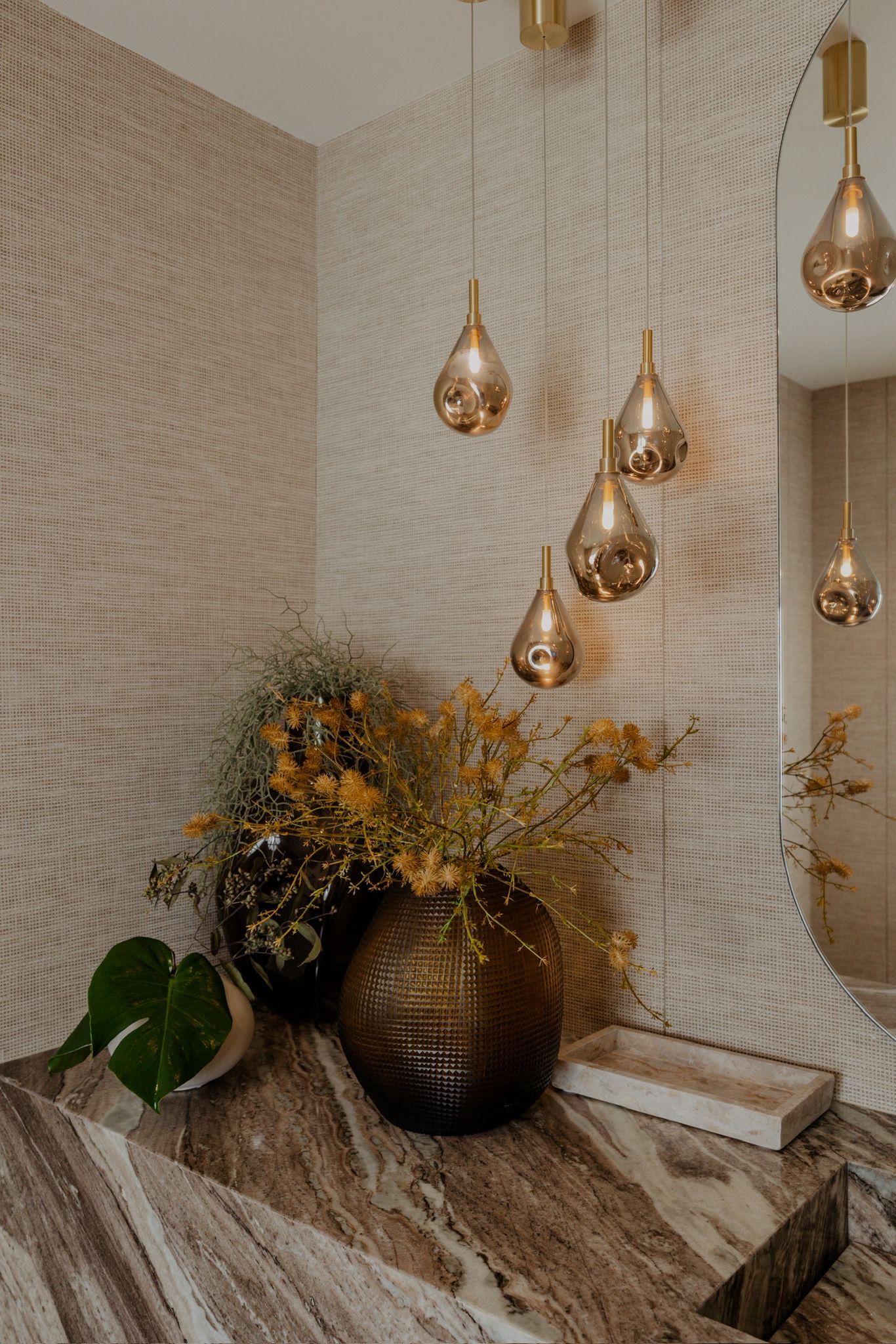 Dining-adjacent living, ribbed chairs, travertine table.